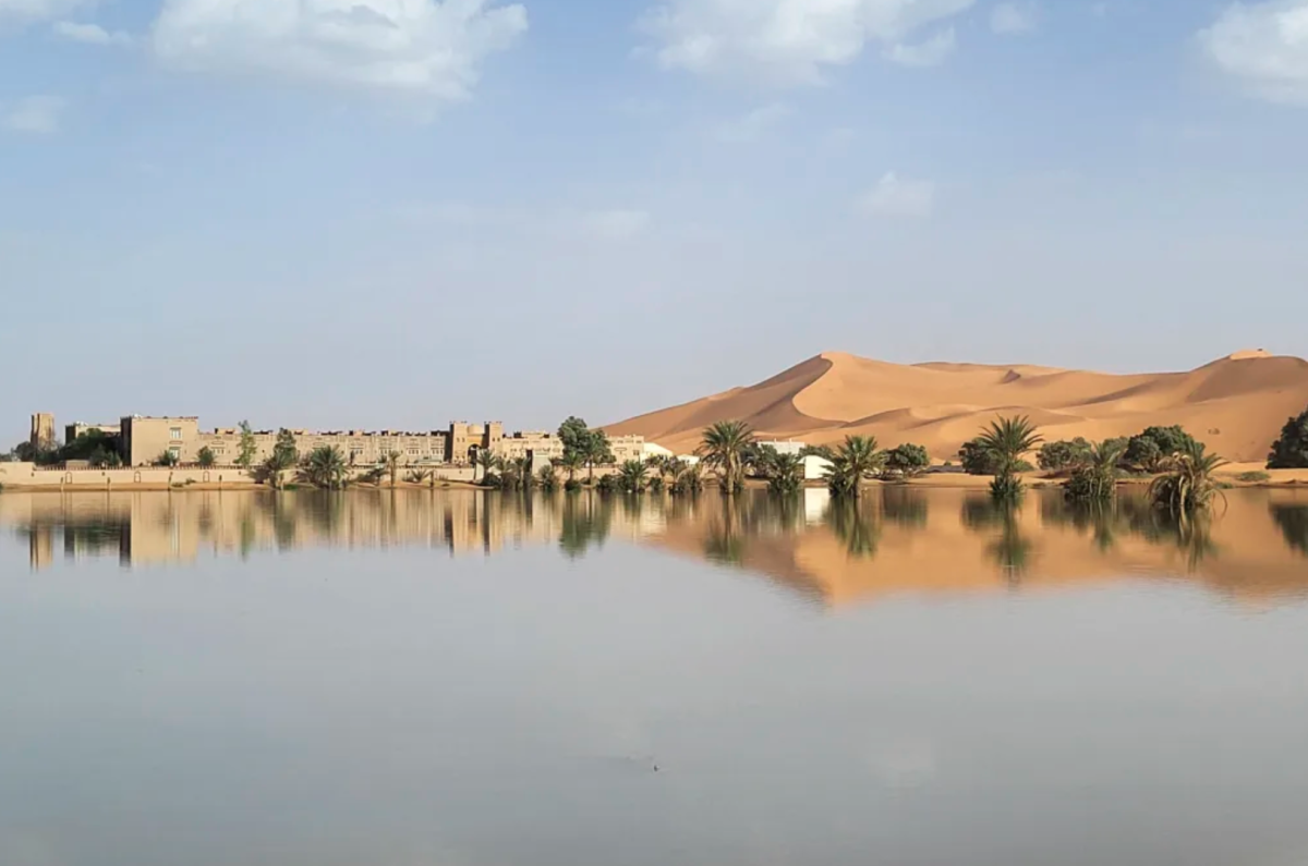 Buildings along a lake filled by heavy rainfall in the desert town of Merzouga on October 2, 2024. 
